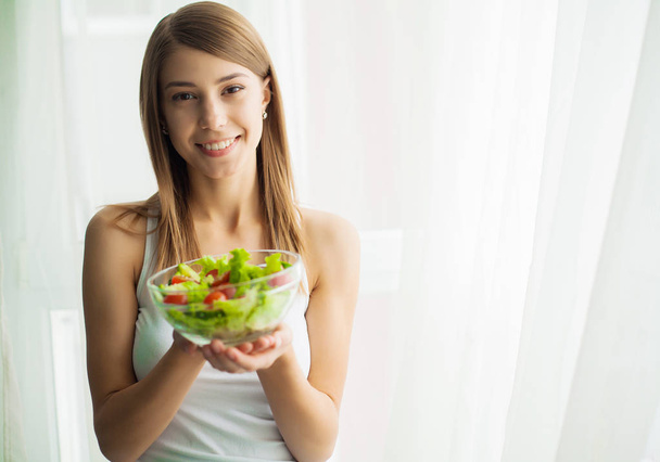 Diet and health.Young woman eating healthy food after workout - Photo, Image
