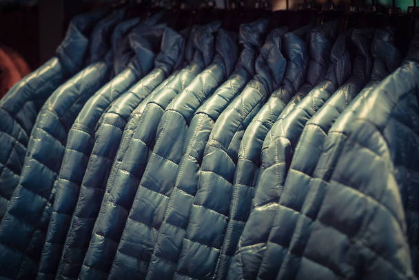 Filtered tone row of women down jackets at American outdoor clot - Photo, Image