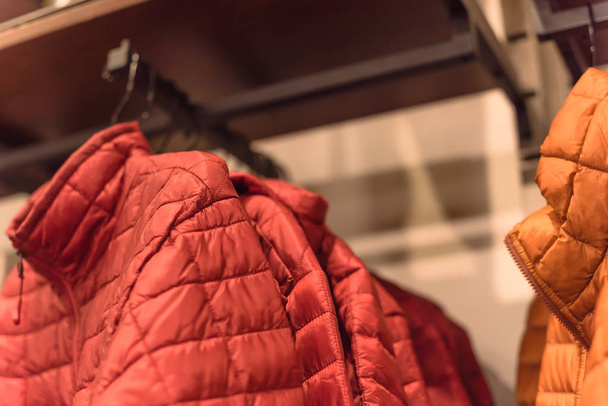 Közeli téli le a ruhát állvány amerikai szabadtéri ruházati boltban. Szigetelt divatos kabát cipzáras zseb. - Fotó, kép