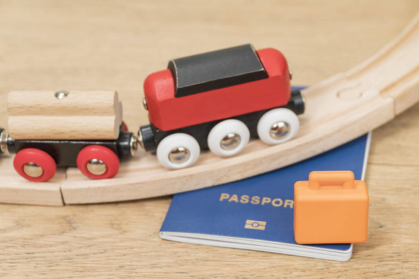 Children wooden railway passes on the passport lying on the table - Foto, imagen