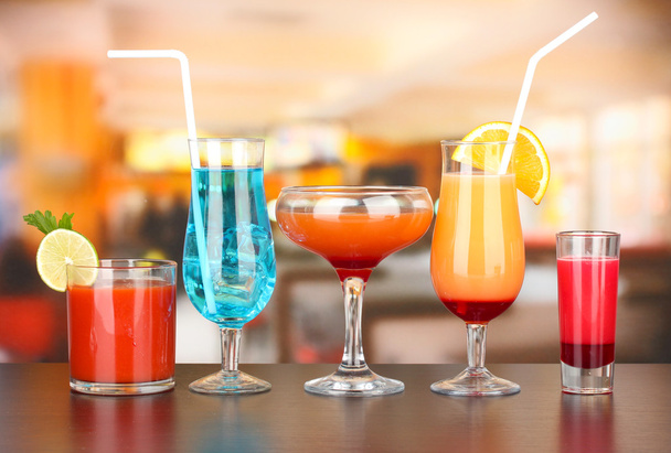 Several glasses of different drinks on bright background - Valokuva, kuva