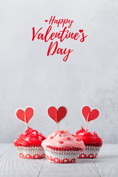 Valentine's day greeting card with delicious sweet cupcakes on grey background - Fotografie, Obrázek