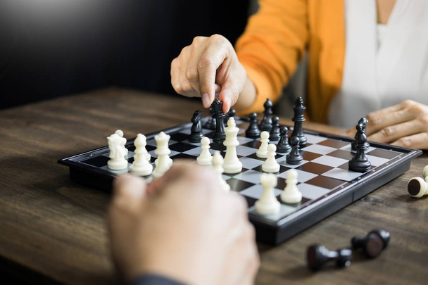 hand of businessman moving chess figure in competition board game for development analysis, strategy idea management or leadership concept - Photo, Image