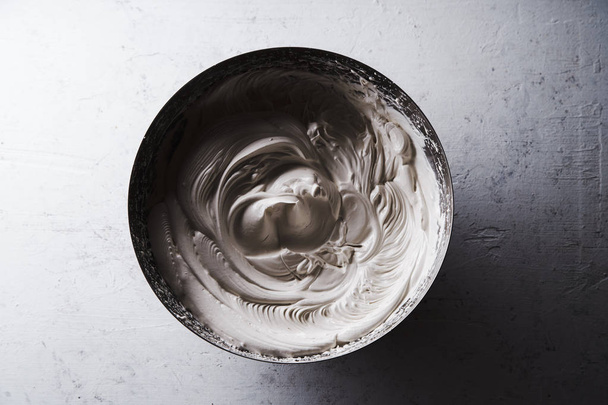 Metallic bowl with egg whites beaten with sugar, concept of meringue cooking - Fotoğraf, Görsel