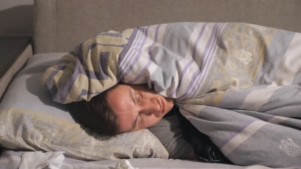 Sick man lying under blanket - Footage, Video