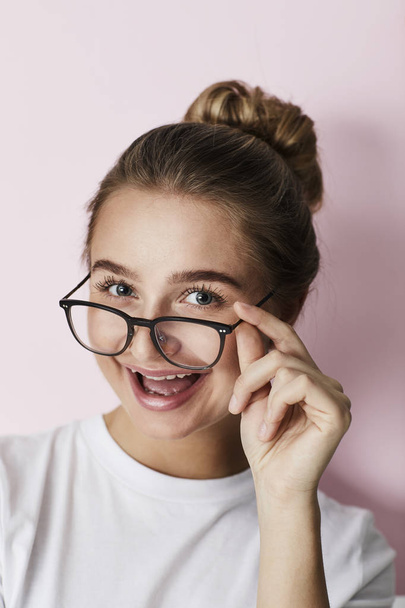 Girl looking over spectacles, portrait - Φωτογραφία, εικόνα