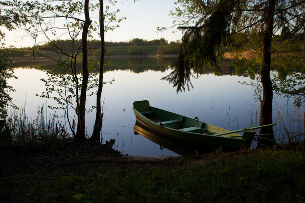 fishing boat in a calm lake water - Foto, Imagen
