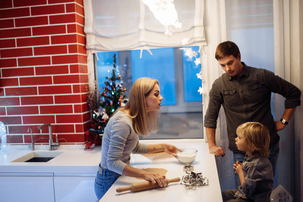 Happy young family making cookies at home  - Zdjęcie, obraz