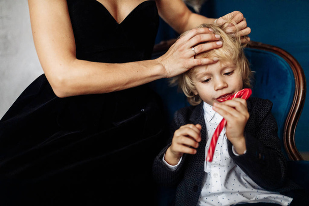 Happy young  mother and her  son  with candy cane  posing  - Photo, Image