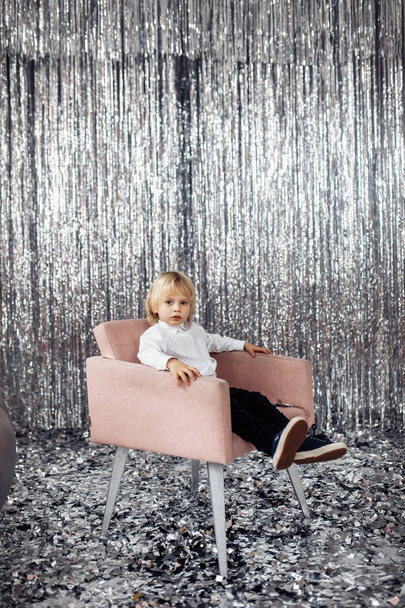 Happy cute boy  sitting on chair in studio - Valokuva, kuva