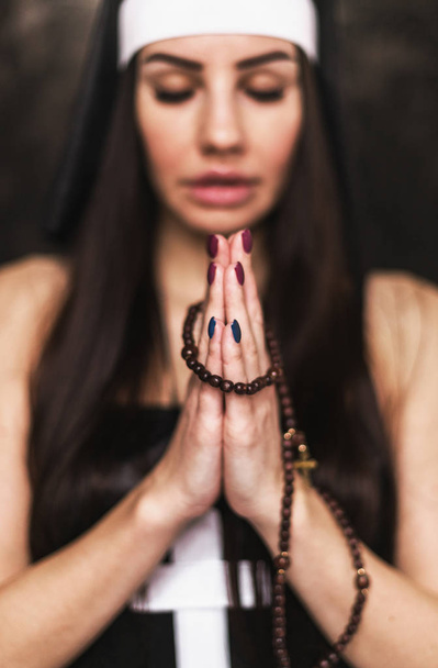 Sexy nun wearing lingerie posing indoors. Woman praying - Foto, afbeelding