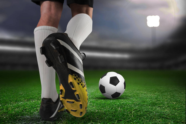 Close up of football boots against close-up of soccer field - Foto, Imagem