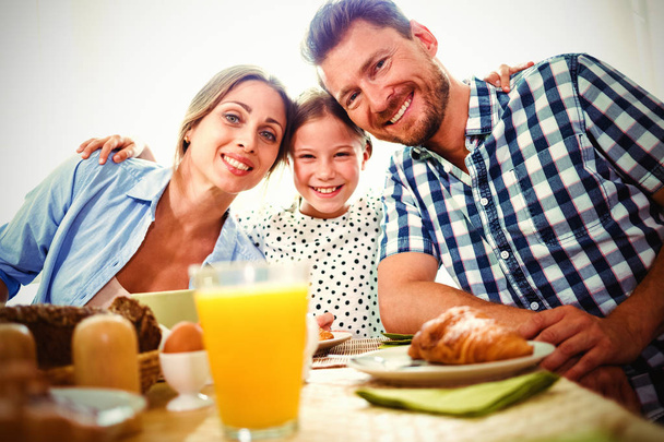 Portrait of happy family having breakfast together at home - Foto, immagini