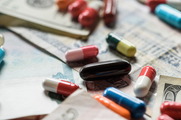 selective focus of different pills on cash background - Fotografie, Obrázek