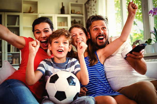 Excited family watching football match at home - Photo, Image