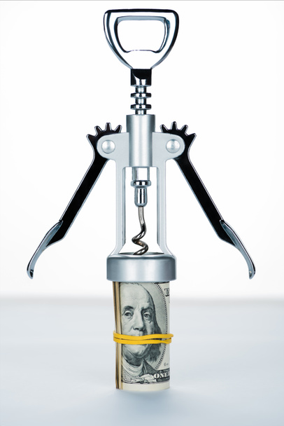 corkscrew with money roll on blurred white and grey background  - Фото, изображение