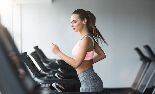 Sports woman doing cardio training on treadmill - Foto, Imagen