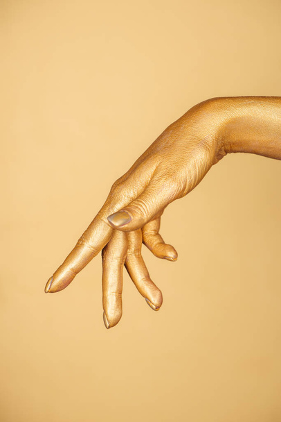 cropped view of female painted hand isolated on gold - Φωτογραφία, εικόνα