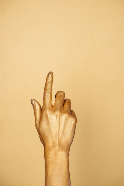 partial view of female painted hand isolated on gold with copy space - Photo, Image