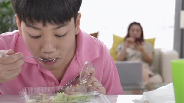 4K asian boy eating lunch at home , Food for lunch, lunchboxes with jasmine rice box. - Footage, Video