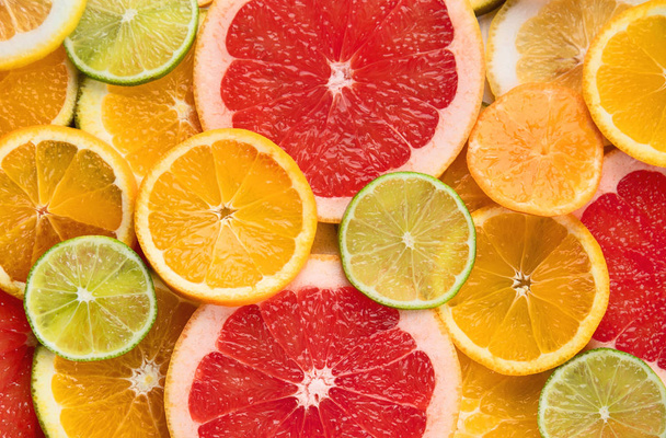 Fresh citrus fruits slices colorful background. - Valokuva, kuva