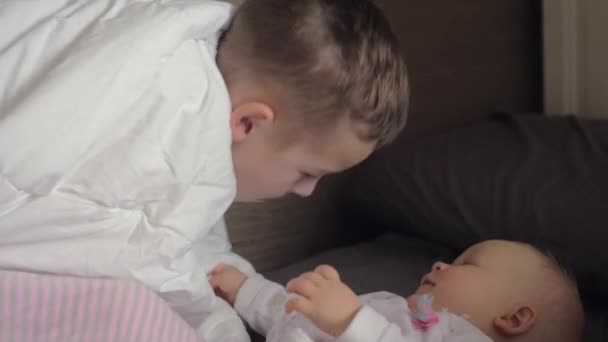 Boy and baby girl siblings playing at home - Кадри, відео
