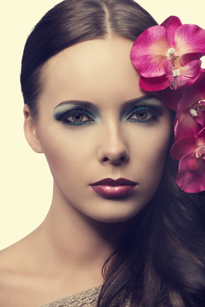 close up of beauty girl with flowers. FAKE FLOWERS - Photo, image
