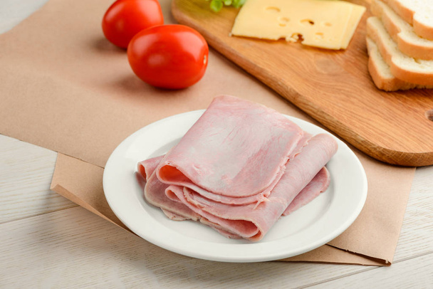 Ham slices on white plate - Photo, image