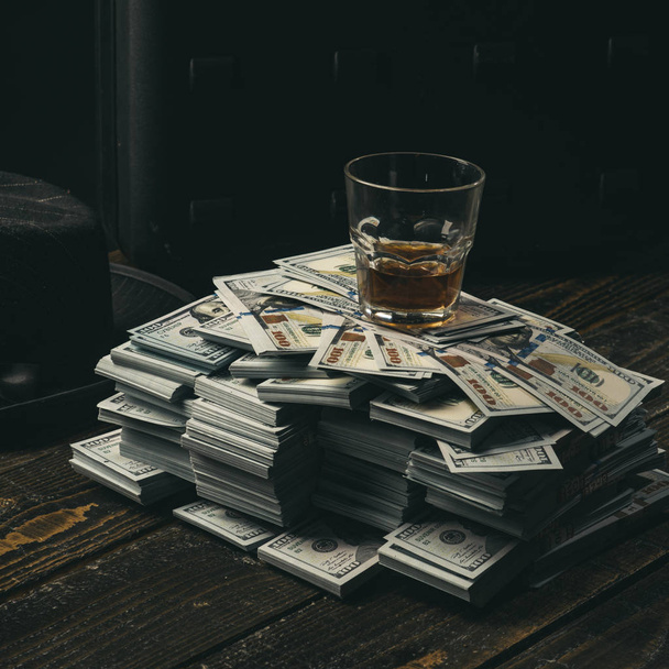 Money transaction. Casino. accountant office. Economy and finance. bookkeeper. Heap of money and alcoholic drink. Mafia. Making money. Small business concept. Mafia is not sleeping - 写真・画像