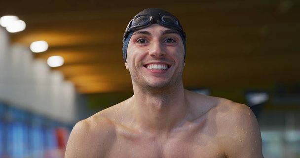 Portrait of smiling professional swimmer satisfied with his results in swimming pool. Concept of sport, competition, fitness. - Fotoğraf, Görsel