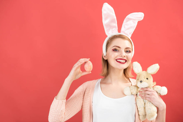 happy woman in bunny ears with toy. Spring holiday. Girl with hare toy. Woman in rabbit bunny ears. Happy easter. Egg hunt. Easter eggs as traditional food. Easter time. copy space - Φωτογραφία, εικόνα