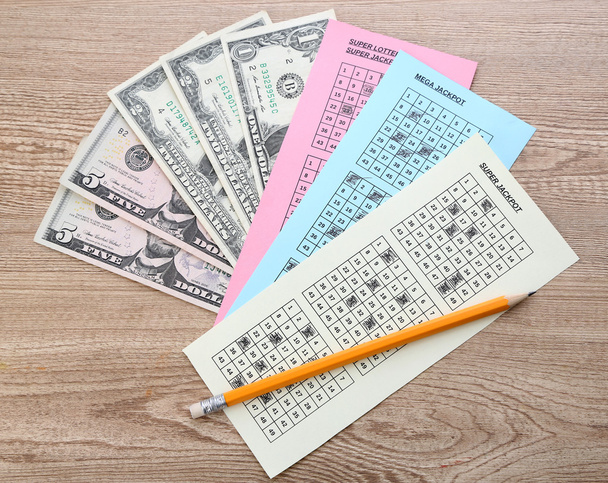Lottery tickets with pencil and money, on wooden background - Foto, Imagem