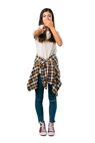 A full-length shot of a Teenager girl with shirt tied to the waist pointing with finger at someone and laughing - Photo, Image