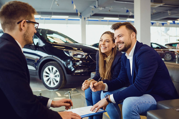 Young Couple buys a car in a car dealership - Photo, Image