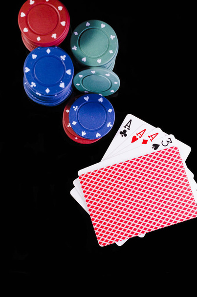 Chips en speelkaarten in een poker spelen op groene en zwarte achtergrond ladder, volledige, paren, trio - Foto, afbeelding