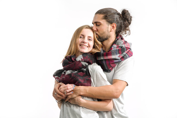 Kiss. Young couple in love in shirts and scarves standing on a light background. Man and woman. - Fotoğraf, Görsel
