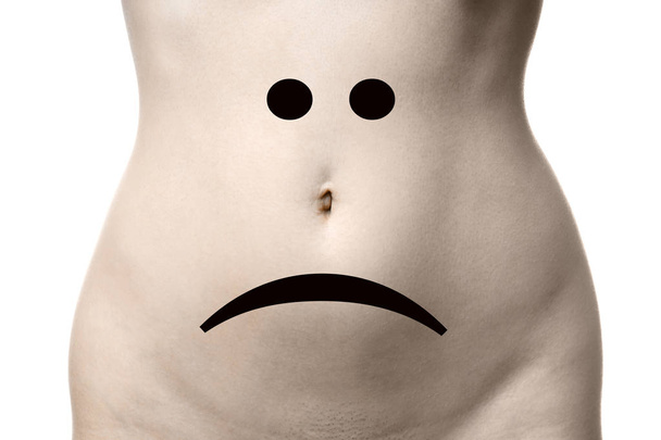 жіночий шлунок з сумним смайликом обличчя
 - Фото, зображення