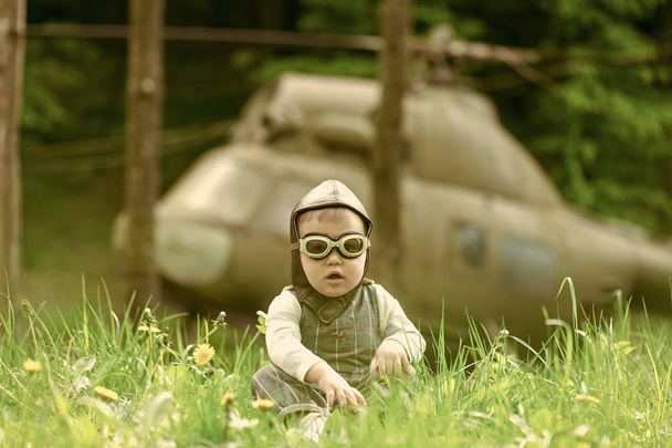 Child and blurred helicopter on natural background - Foto, Imagem