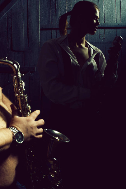 woman with microphone and man with sax - Photo, Image