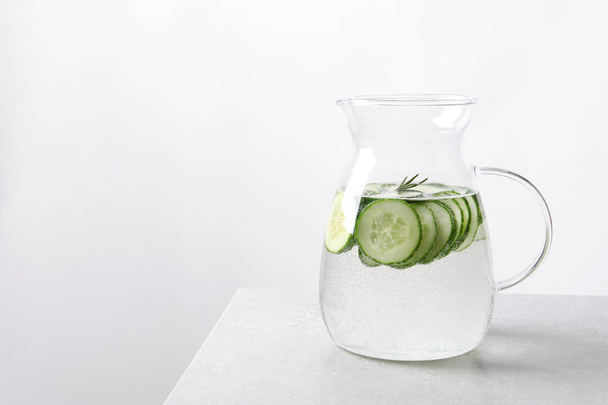 Jug of fresh cucumber water on table. Space for text - Photo, image