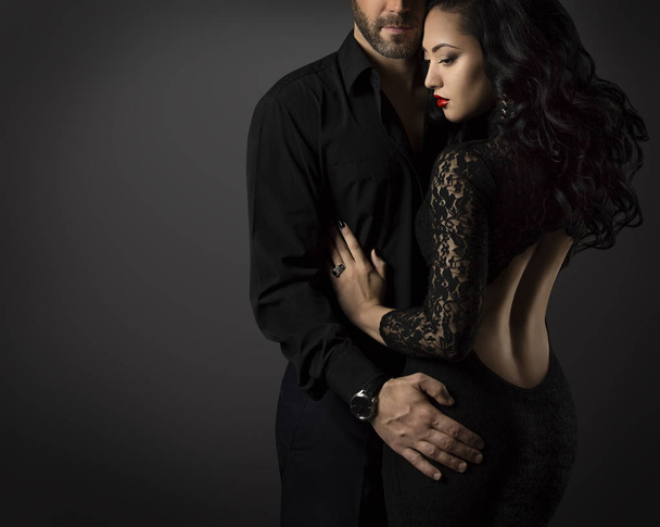 Couple Fashion Portrait, Embracing Man and Sexy Woman in Black Dress - Photo, image