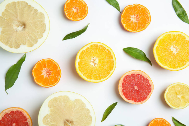 Different citrus fruits on white background, flat lay - Фото, изображение