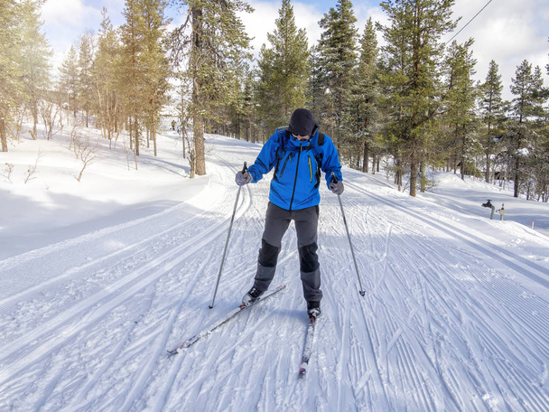 A man cross-country skiing on the trail in Finland - Photo, image