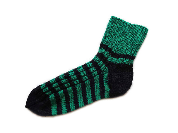 Mão malha artesanal lã natural listrado padrão preto e verde quente meia acessório isolado no fundo branco
  - Foto, Imagem