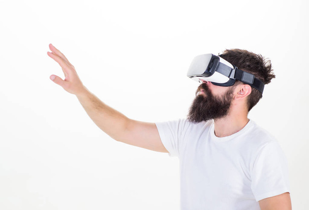Interactive surface virtual reality concept. Guy with head mounted display interact virtual reality. Hipster exploring virtual reality. Virtual life. Man bearded hipster VR glasses white background - Foto, Imagen