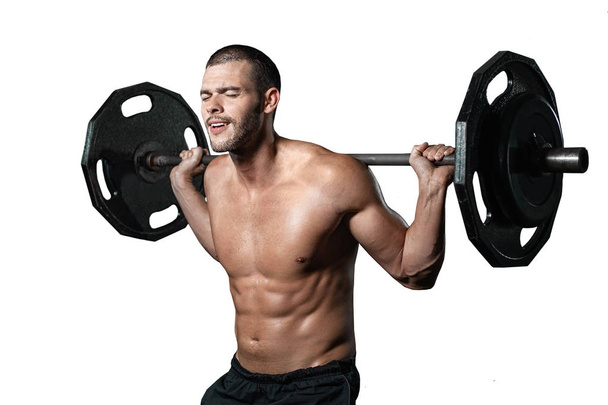 isolated handsome weightlifter lifting barbells with Squats. Male training with barbell, pumping legs - Fotoğraf, Görsel