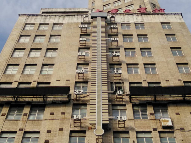 View of a building with the huge thermometer showing outdoor temperatures in Shanghai, China, 14 June 2017 - Photo, Image
