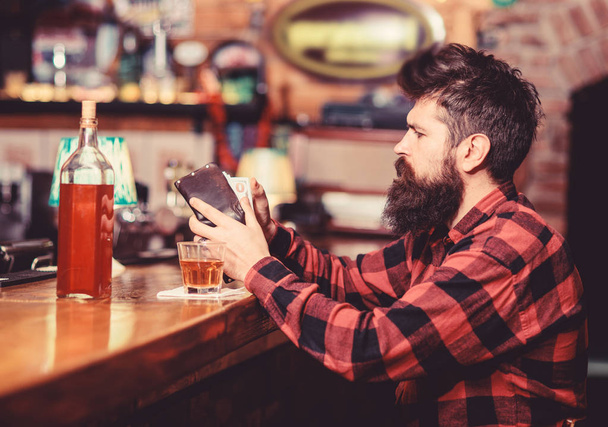 Hipster holds wallet, counting money to buy drinks. - Photo, Image