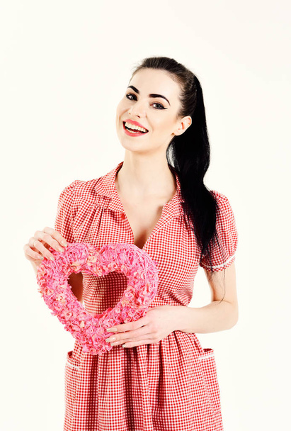 Valentines day conept. Girl with make up holds symbol of Valentines day - Фото, изображение