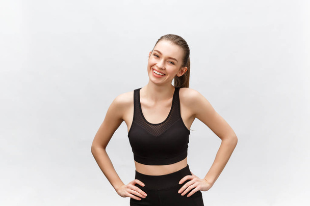 Image of a beautiful strong happy cheerful young sports woman posing isolated on grey background. - Фото, зображення